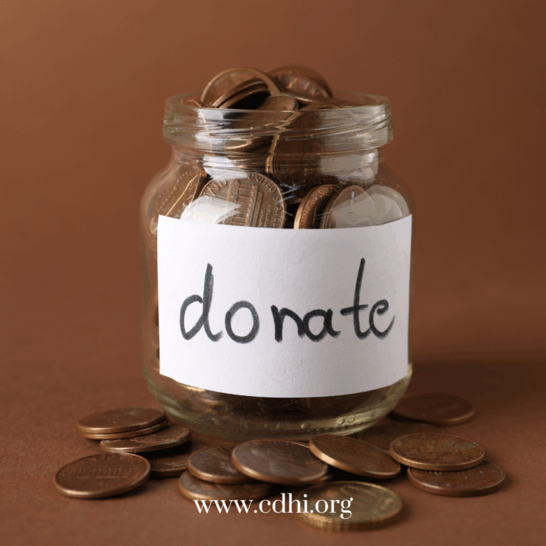 Donation jar filled with coins and a handwritten 'Donate' label; coins spill on the table, website www.cdhi.org visible at bottom.