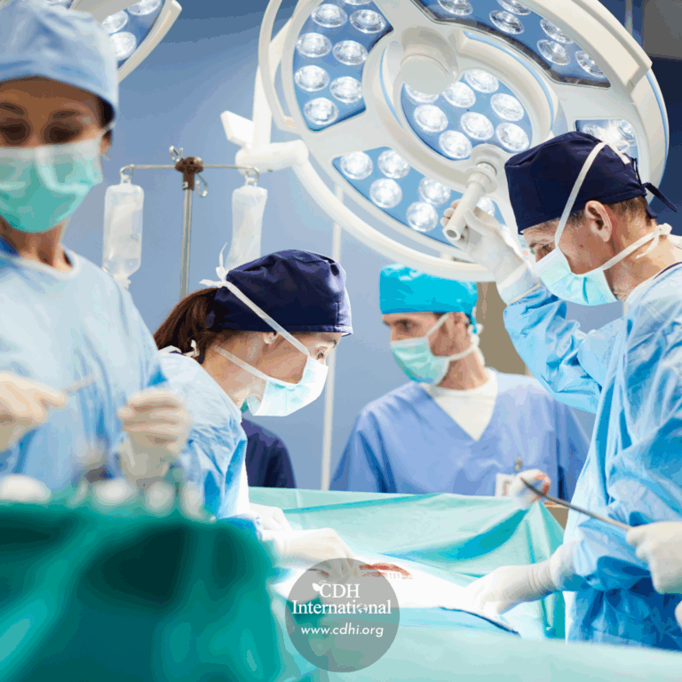Surgical team in blue scrubs and masks performing surgery under bright overhead operating lights.