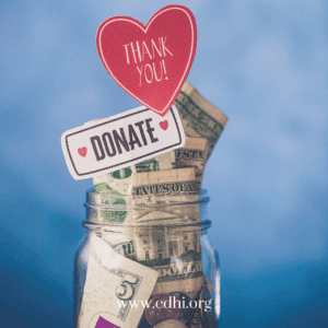 Jar full of dollars and coins with a 'Donate' sign and a red heart saying 'Thank you!' above it, promoting donations, www.cdhi.org visible at the bottom