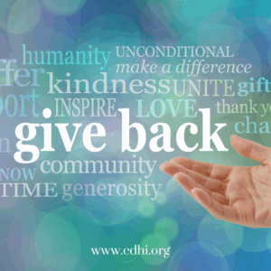 Hand extending toward a large 'give back' word and a cloud of charity-related words on a teal-blue background; includes the URL www.cdhi.org for a charity/volunteer message.