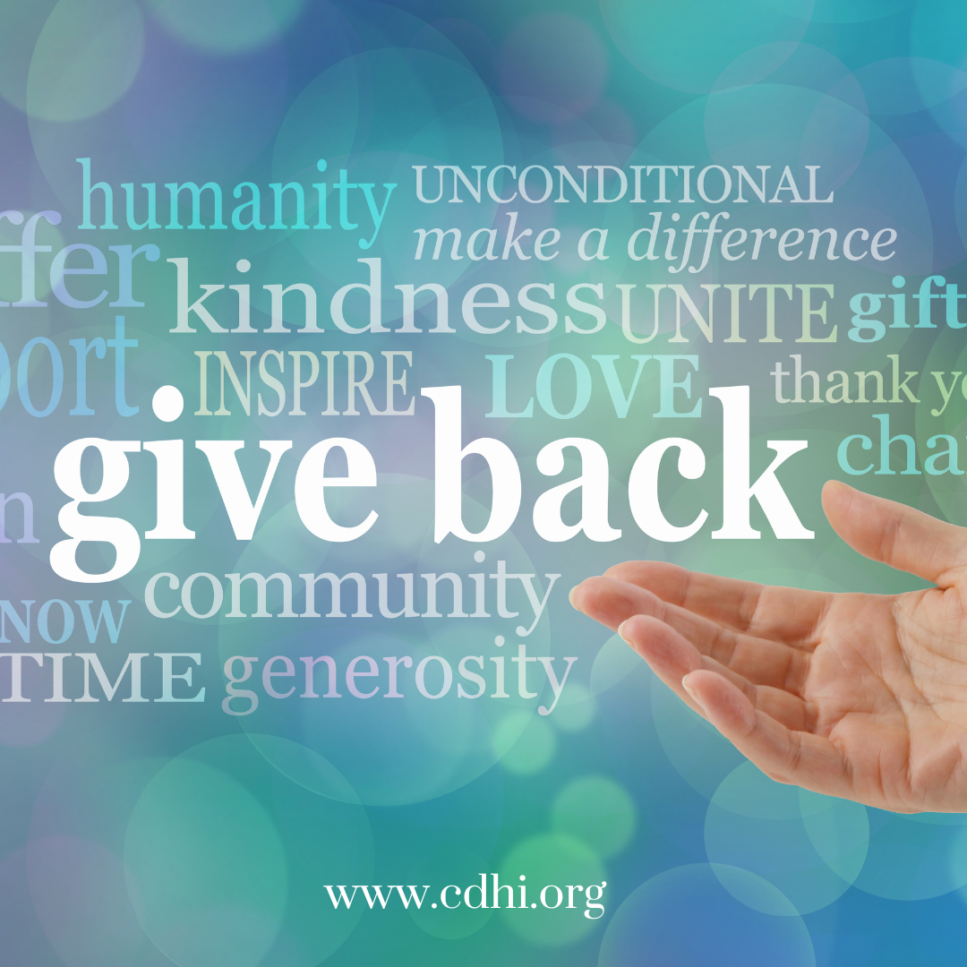 Hand extending toward a large 'give back' word and a cloud of charity-related words on a teal-blue background; includes the URL www.cdhi.org for a charity/volunteer message.